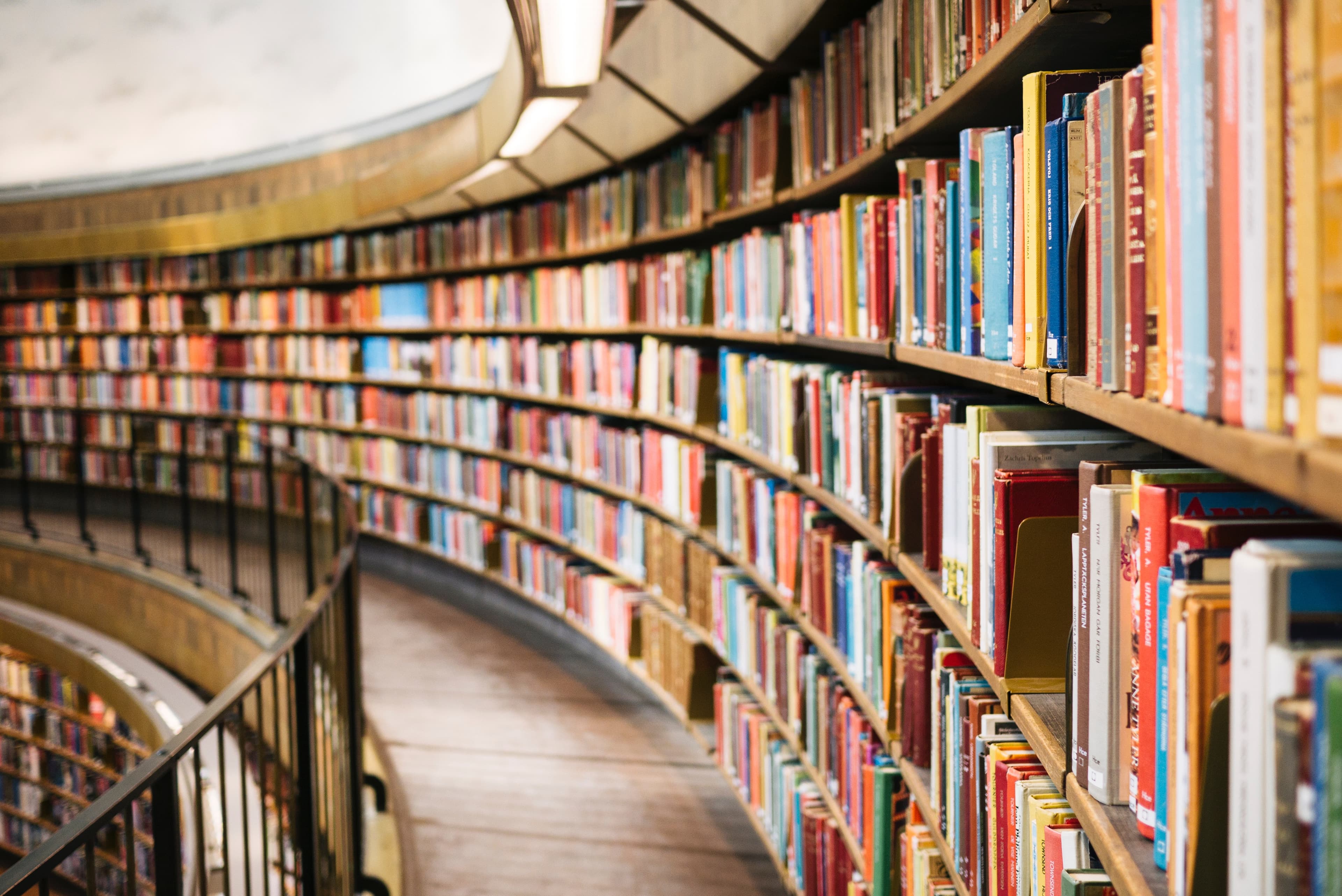 Curved library bookshelves representing final MBA application review
